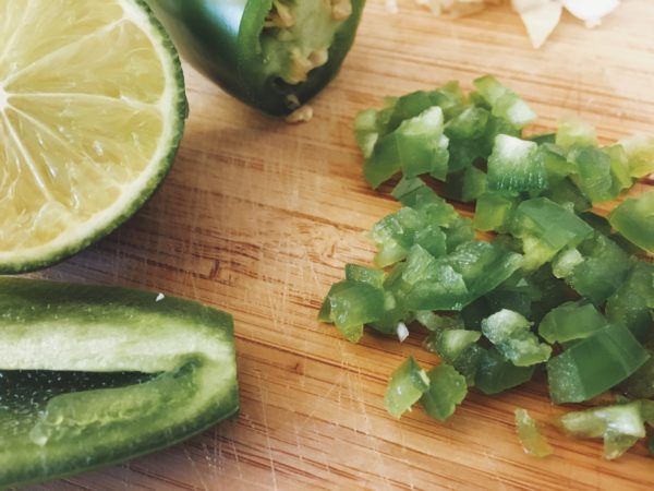 Chopped jalepeno and lime on a cutting board