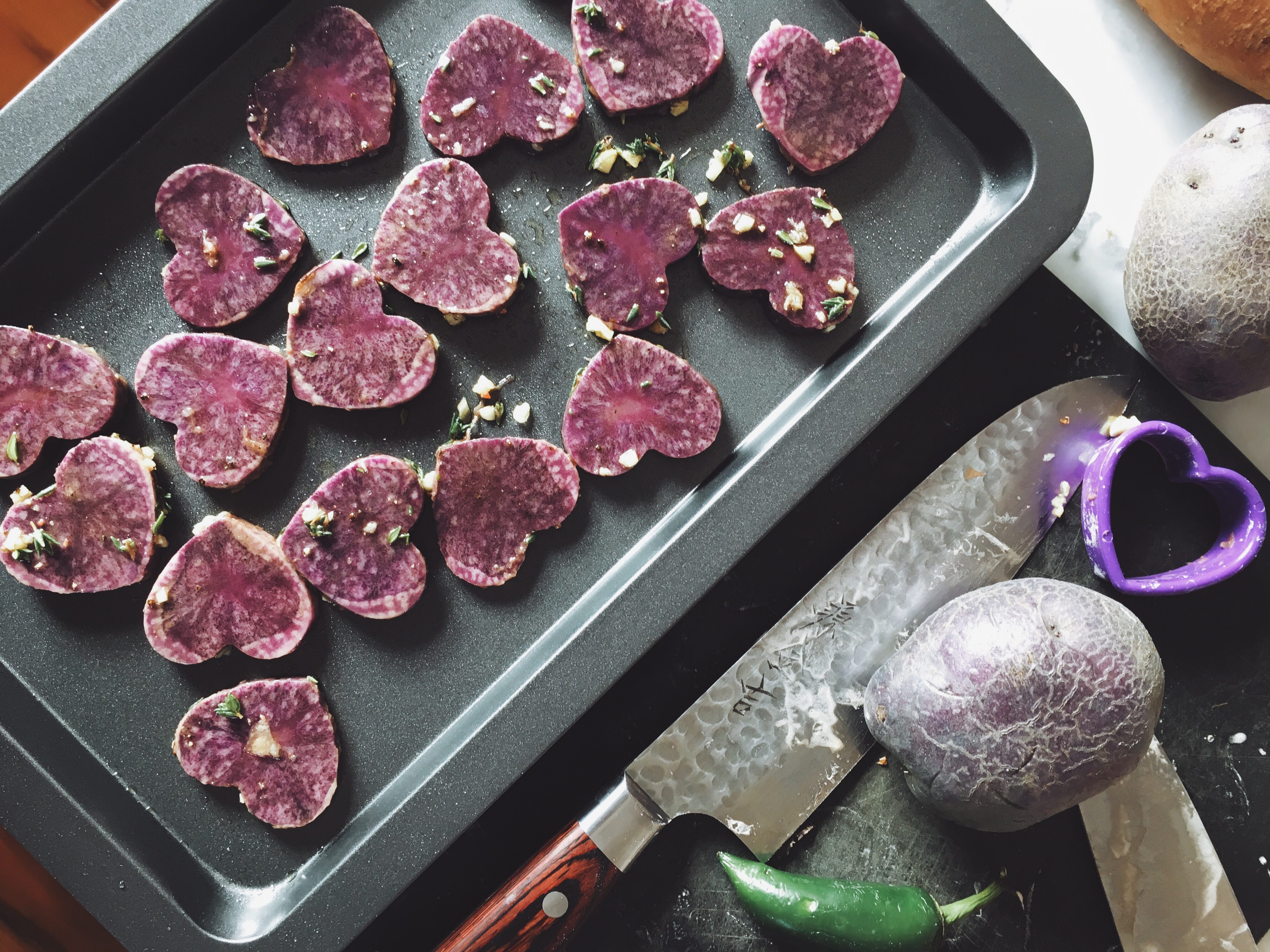 Purple potato hearts on baking tray